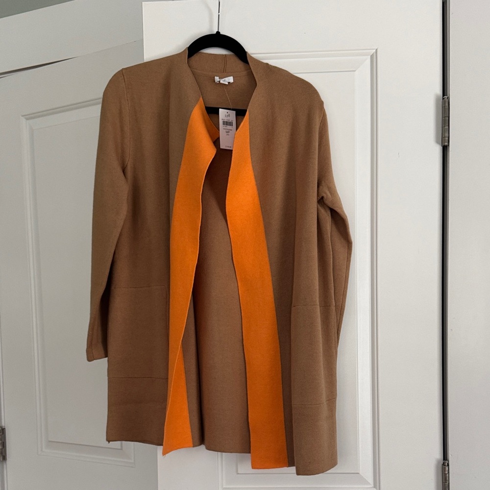 Pure Jill cardigan ends just above the knee. Beige with orange collar accent.